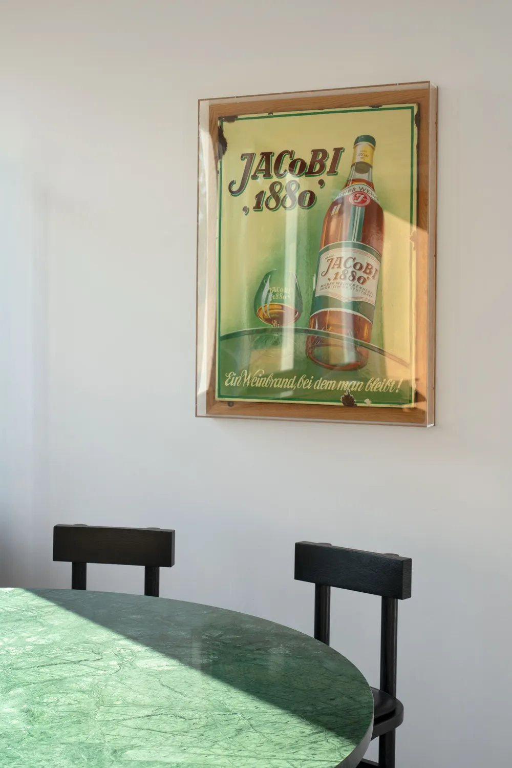 Historisches JACoBI-1880-Werbeschild über einem grünen Marmortisch